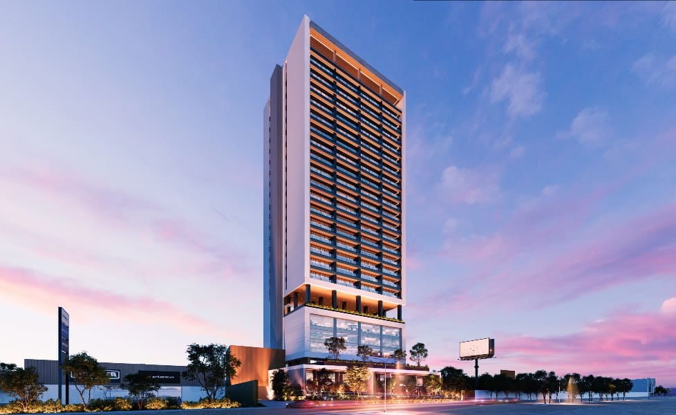 a tall building with trees and a street in the background