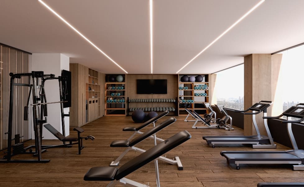 a room with exercise equipment and a tv