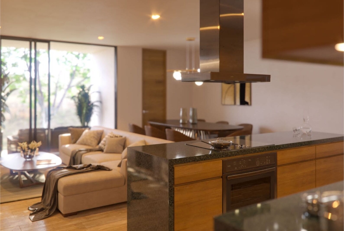 a living room with a couch and a kitchen